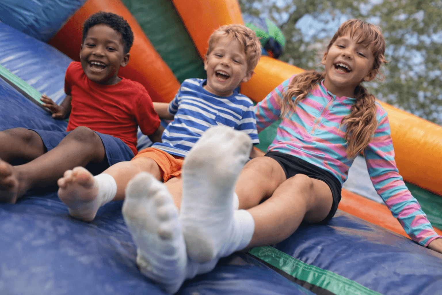 Kids laughing on a jumping castle
